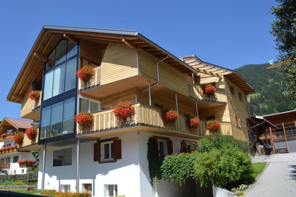 a house with flowers on the balconies of it at Apartments Bachmann in San Candido