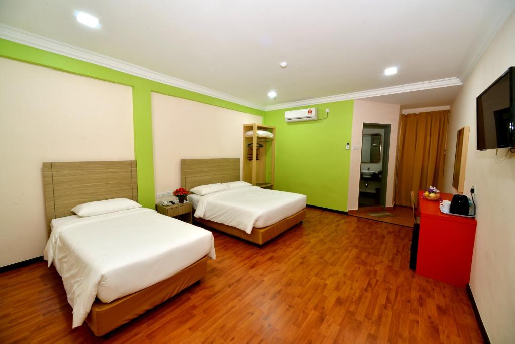 Postel nebo postele na pokoji v ubytování Classic Boutique Hotel Kuantan
