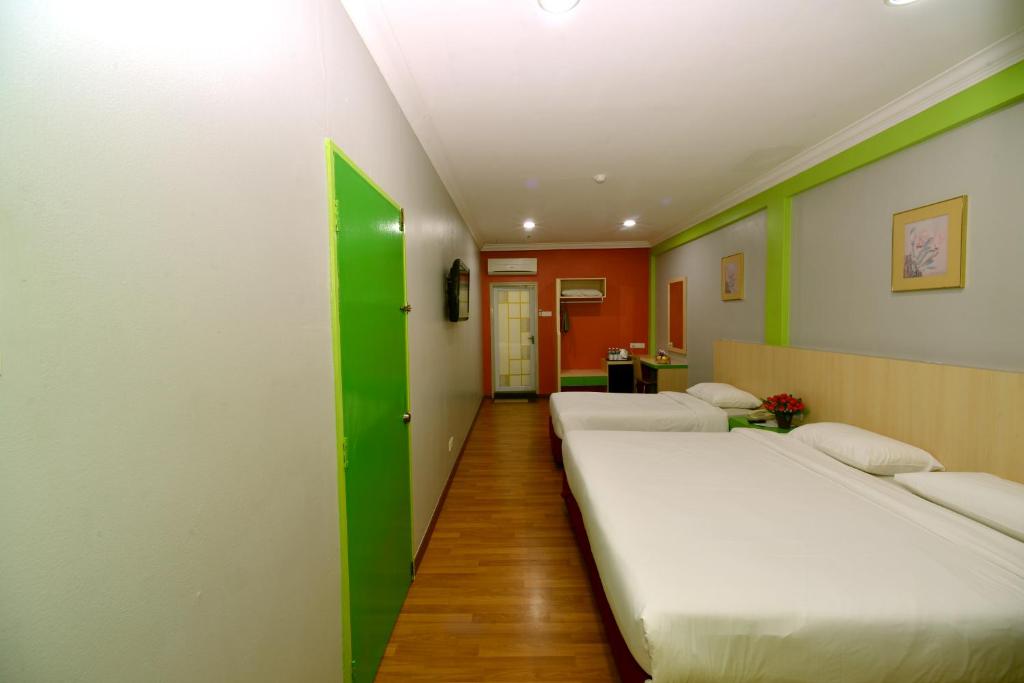 Postel nebo postele na pokoji v ubytování Classic Boutique Hotel Kuantan