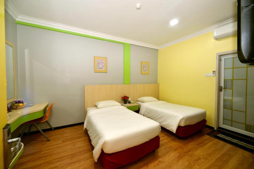 Postel nebo postele na pokoji v ubytování Classic Boutique Hotel Kuantan