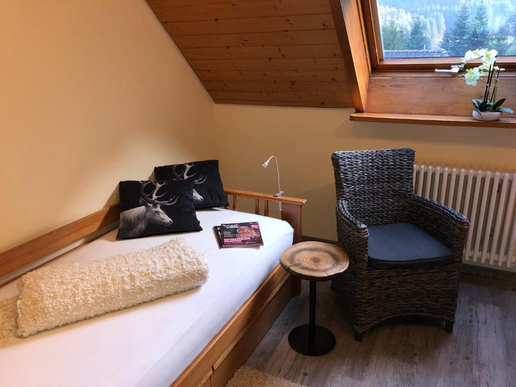 Habitación pequeña con cama y silla en Kempfenhof, en Seelbach