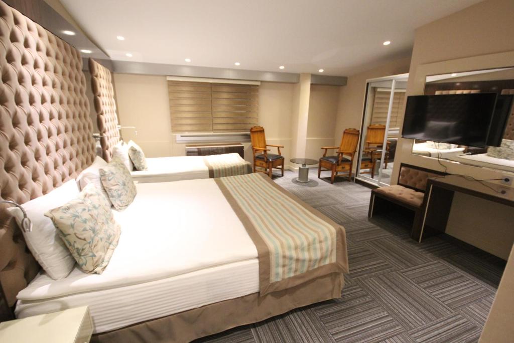 Postel nebo postele na pokoji v ubytování Ankara Gold Hotel