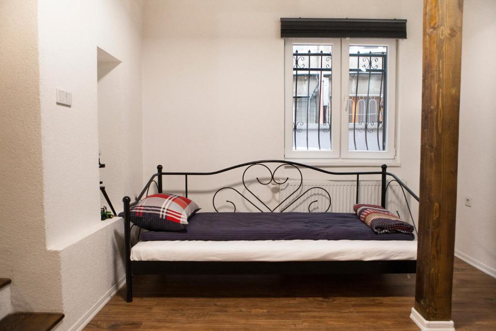 a bed in a room with a window at Apartment Milk&Honey - free Parking in Sarajevo