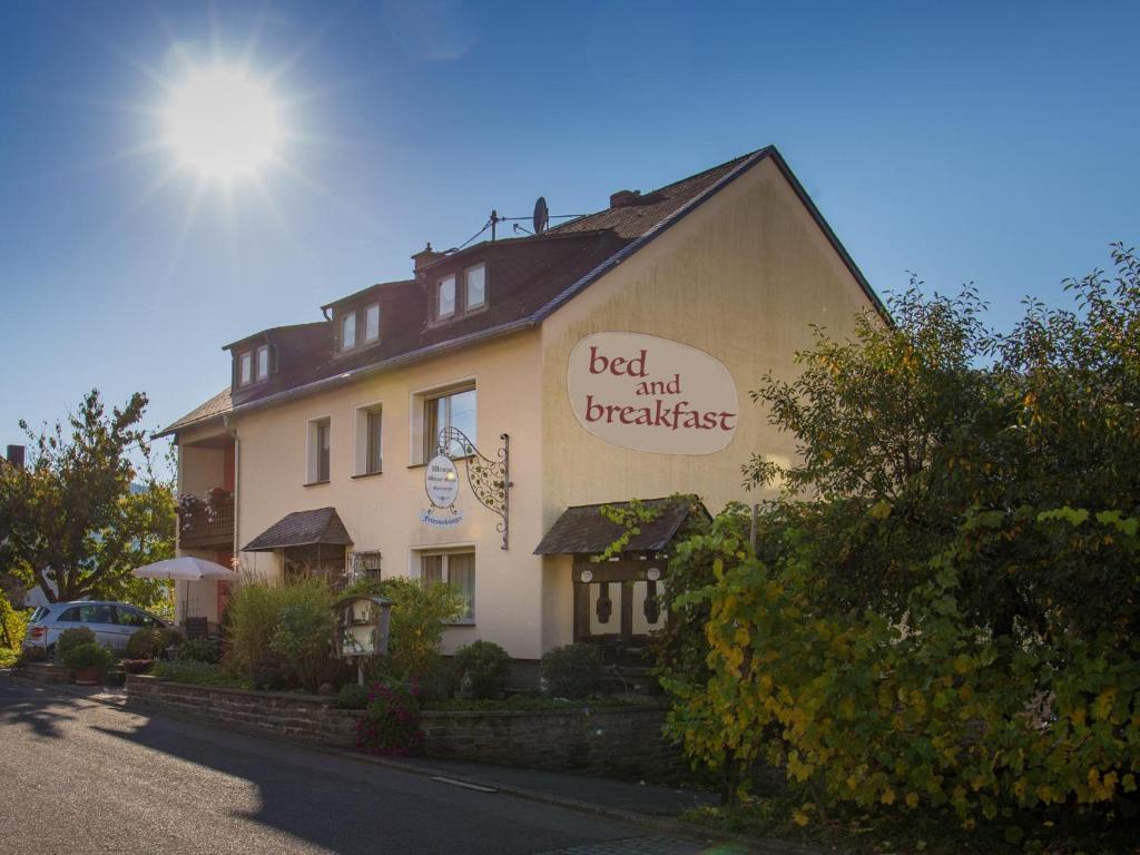 a building with a sign that reads bed and breakfast at Bed & Breakfast Sandra Müller in Burg (an der Mosel)