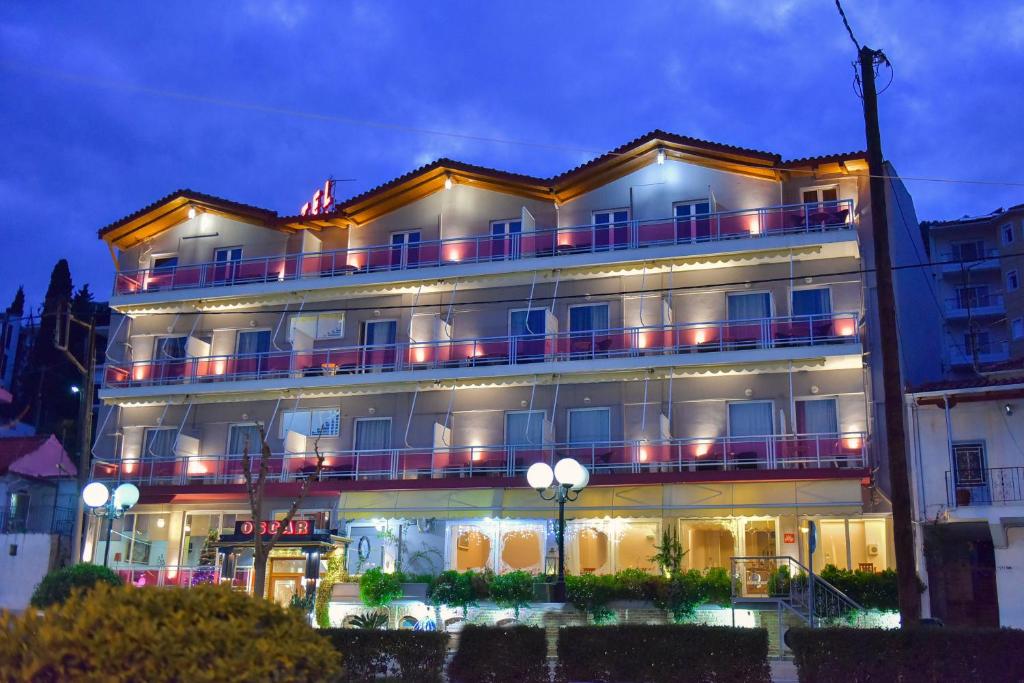 a large building with lights on it at night at Oscar Hotel in Amfilochía