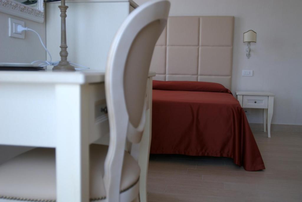 Postel nebo postele na pokoji v ubytování Hotel Gradara
