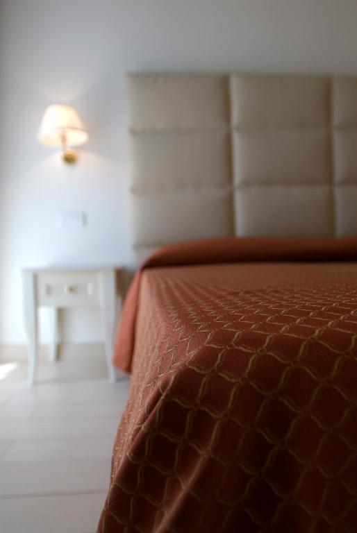Postel nebo postele na pokoji v ubytování Hotel Gradara