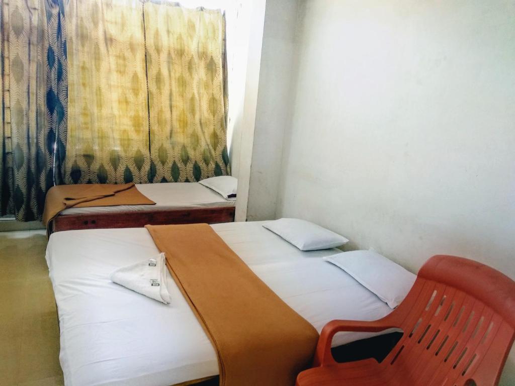 Postel nebo postele na pokoji v ubytování Hotel Ashwini Lodge