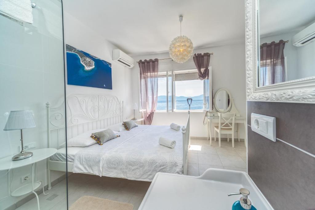 a bedroom with a bed and a glass shower at Holiday Home Labineca in Gradac