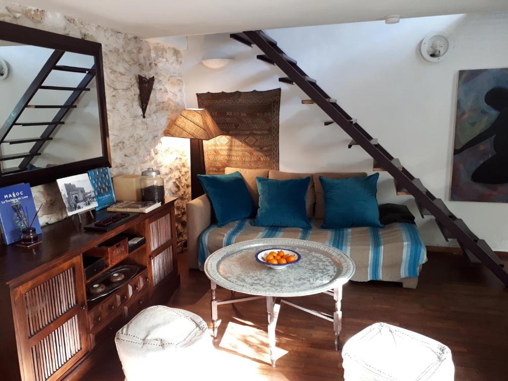 a living room with a couch and a table at Maison de Ville in Marseille