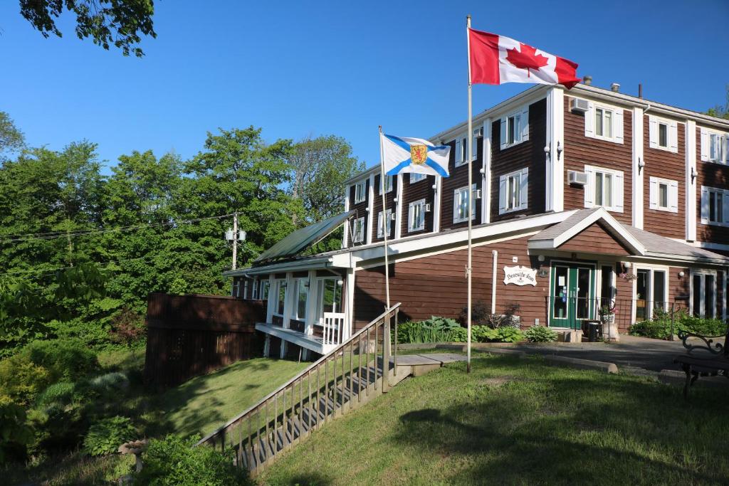 
a large building with a flag on top of it at Braeside Country Inn in Pictou
