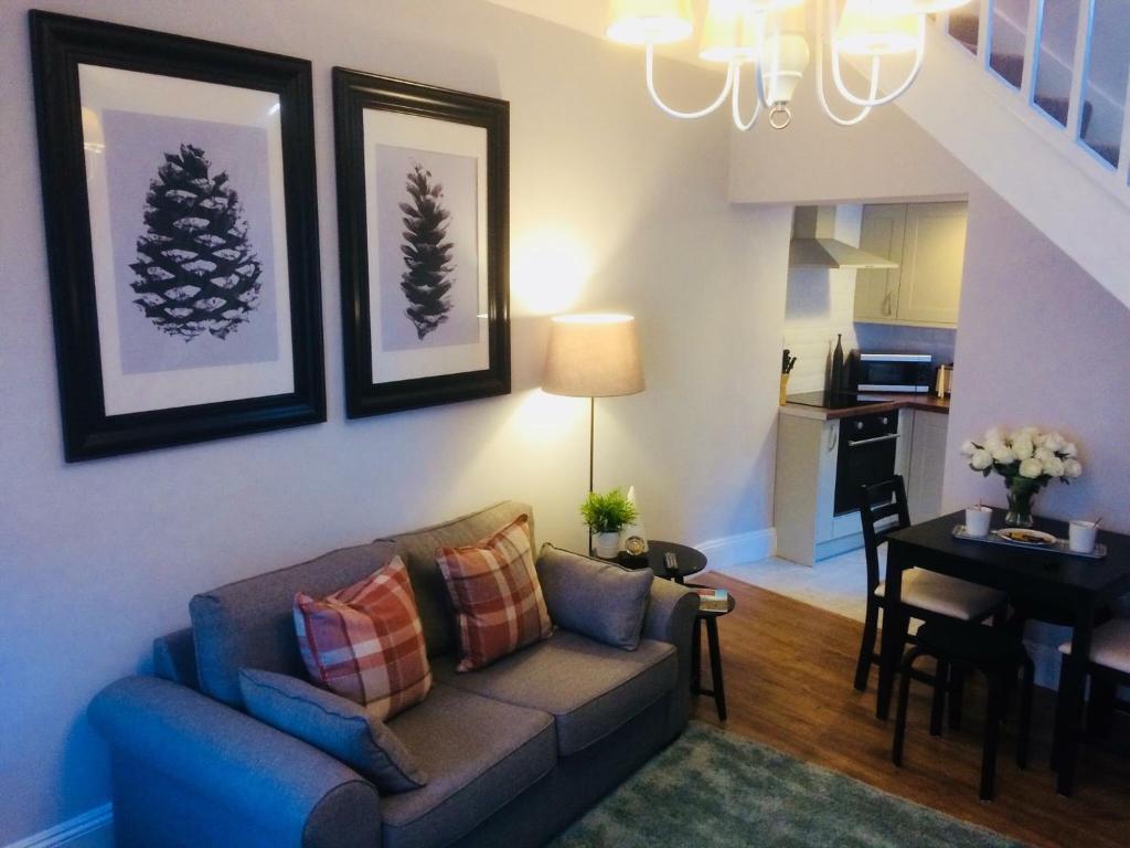 a living room with a couch and a dining room at Brampton Holiday Cottage in Brampton