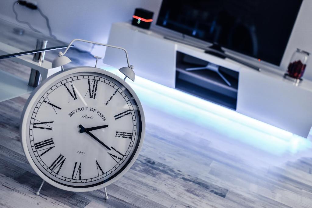 a clock sitting on the floor in a room at New designed Apartment in Vienna in Vienna