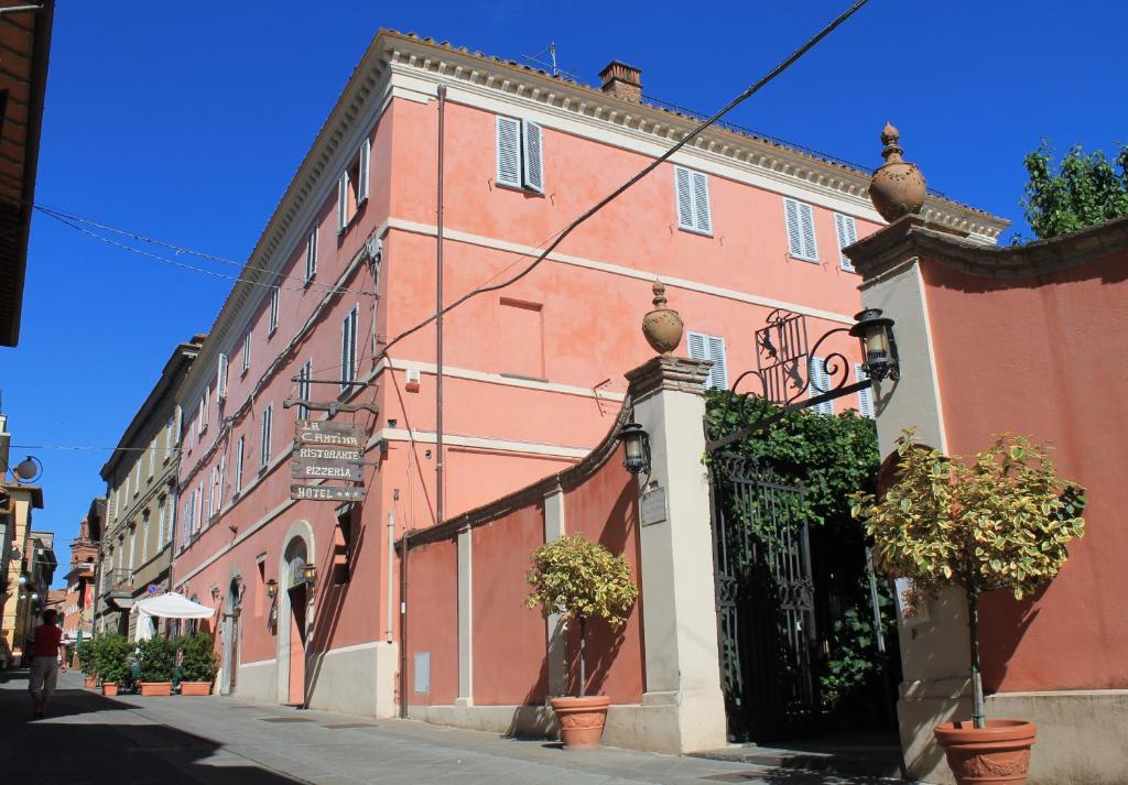 a large pink building on a city street at Hotel Aganoor in Castiglione del Lago