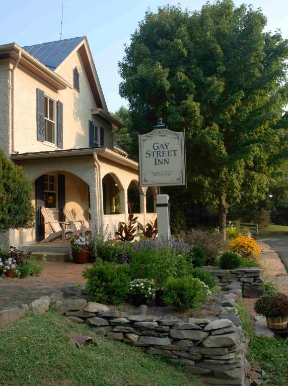 a sign in front of a house with a stay smart sign at Gay Street Inn in Washington, Virginia