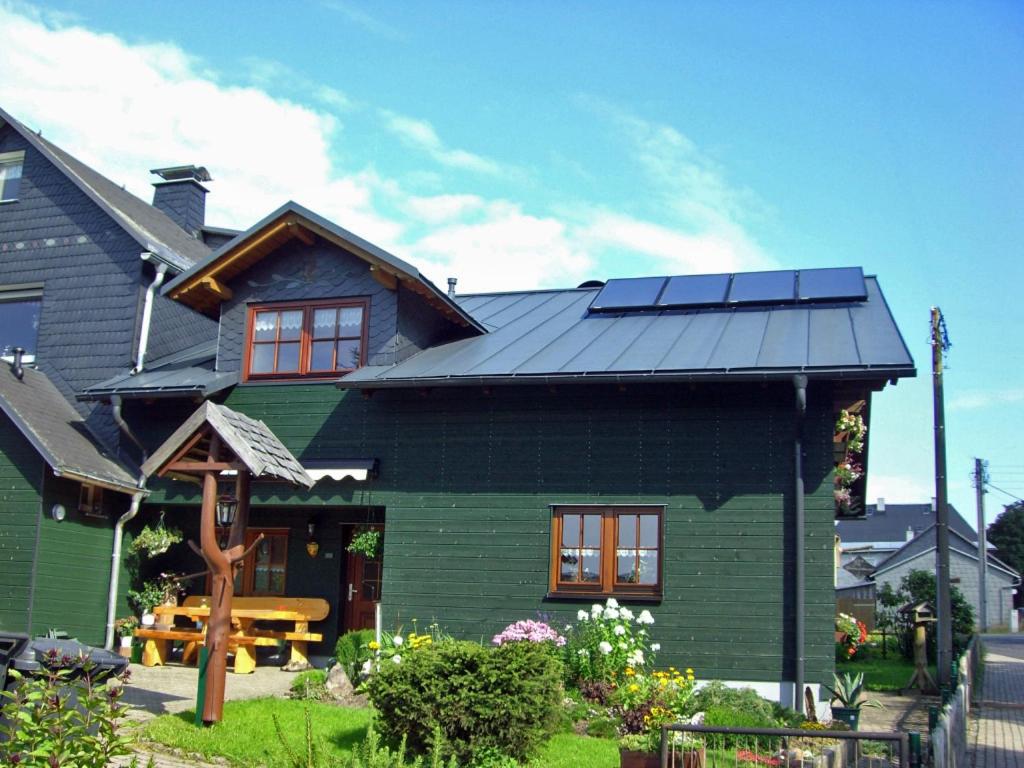 イルメナウにあるFerienwohnung Katrin Spindlerの屋根に太陽光パネルを敷いた家
