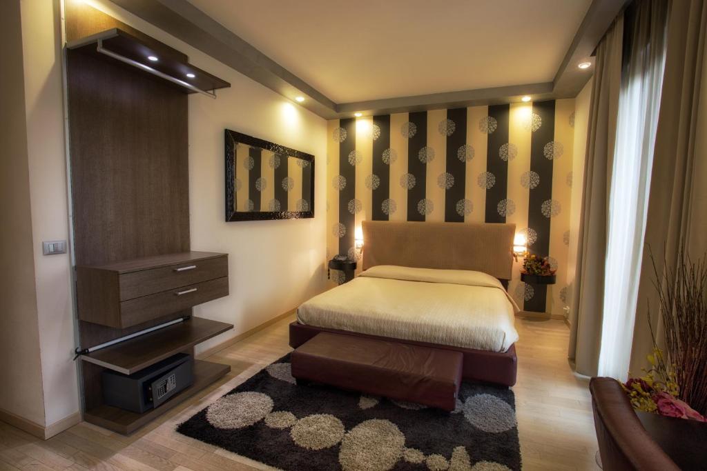 Posteľ alebo postele v izbe v ubytovaní La Grotta Hotel