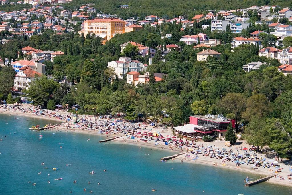 a beach with a lot of people on it at Sandy Beach Apartments in Crikvenica