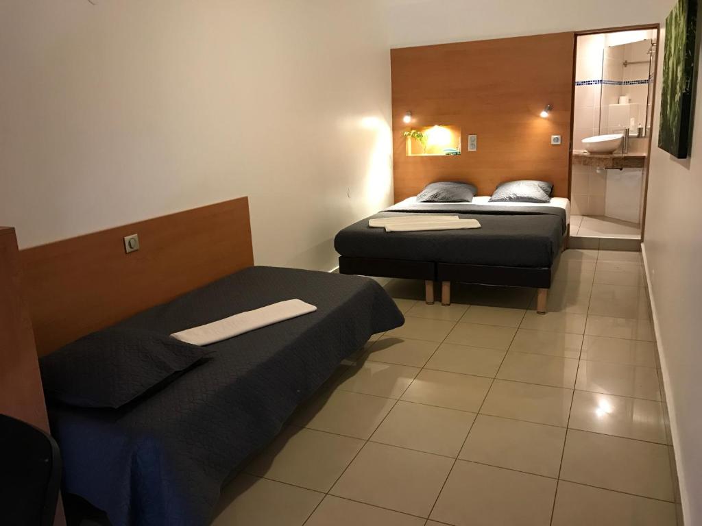 Postel nebo postele na pokoji v ubytování Karaibes Hotel