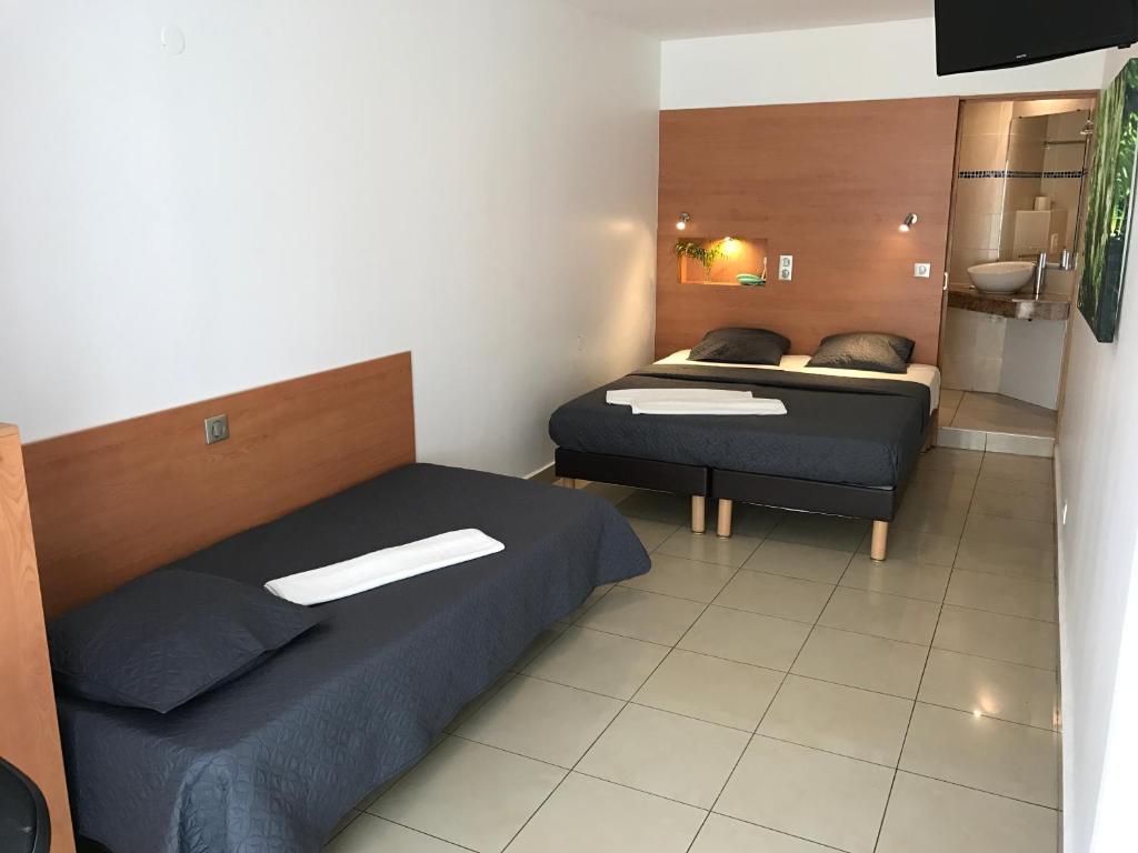 Postel nebo postele na pokoji v ubytování Karaibes Hotel