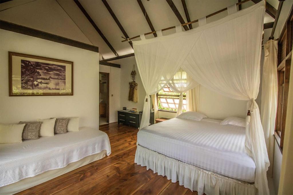 Ένα ή περισσότερα κρεβάτια σε δωμάτιο στο Le Coconut Lodge