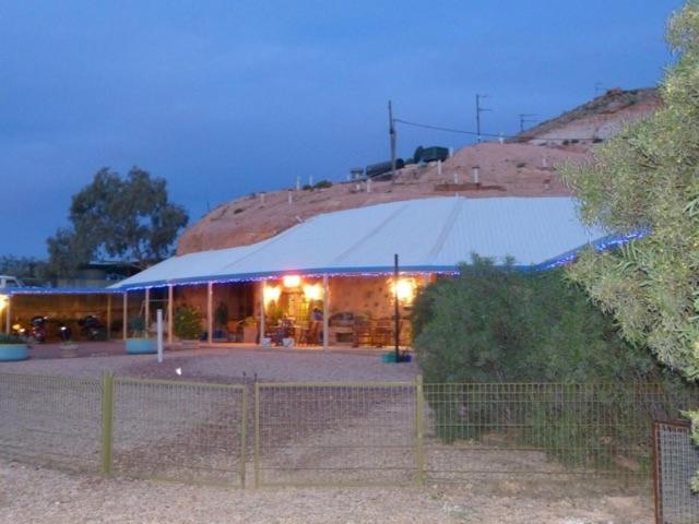 a building with a large tent in front of it at The Underground Motel in Coober Pedy