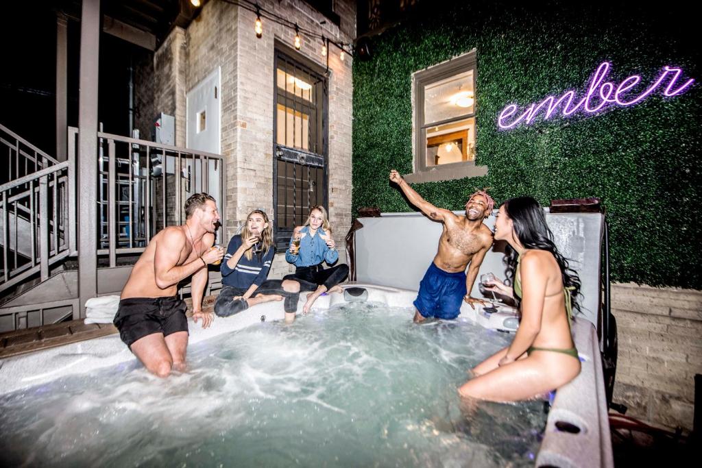 a group of people sitting in a hot tub at Ember Hostel in Denver