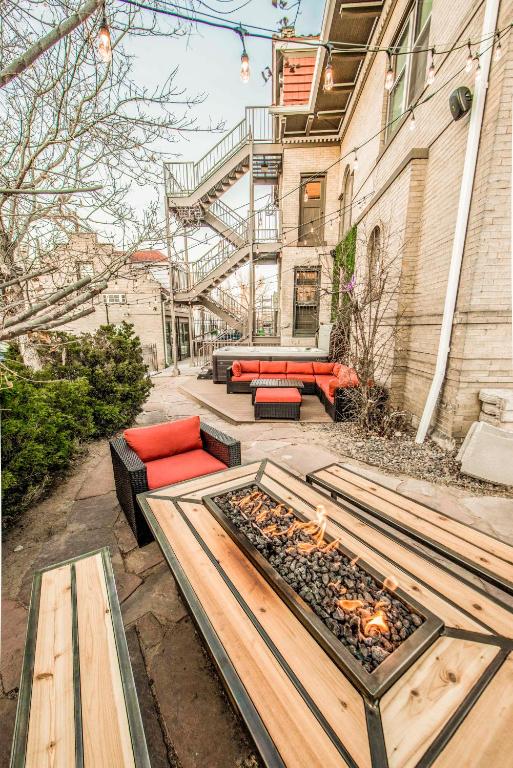 a patio with couches and a fire pit at Ember Hostel in Denver