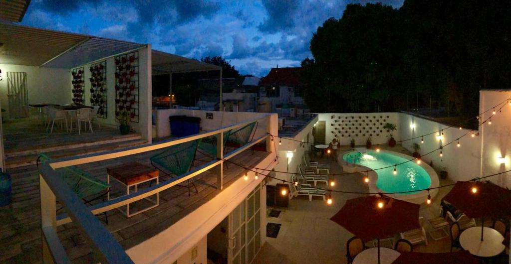 a view of a balcony with a swimming pool at night at Moloch Hostel & Suites in Cancún