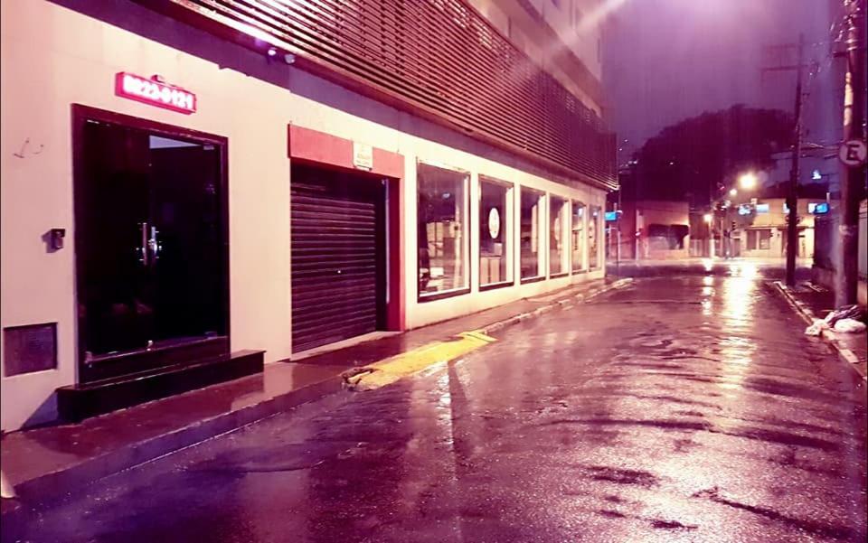 an empty street in a city at night at Joy Hotel in São Paulo