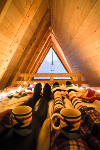 a group of people laying on a bed with cups at Villa Kalaja in Novoberdo