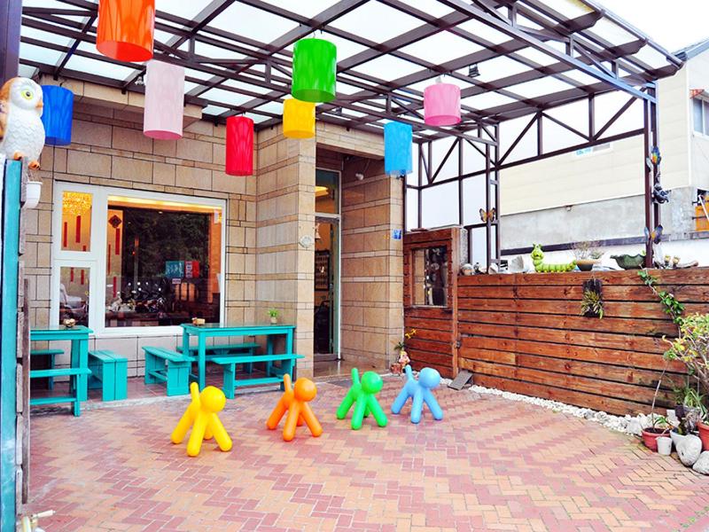 a group of puppets sitting outside of a building at 華納小筑 in Kenting