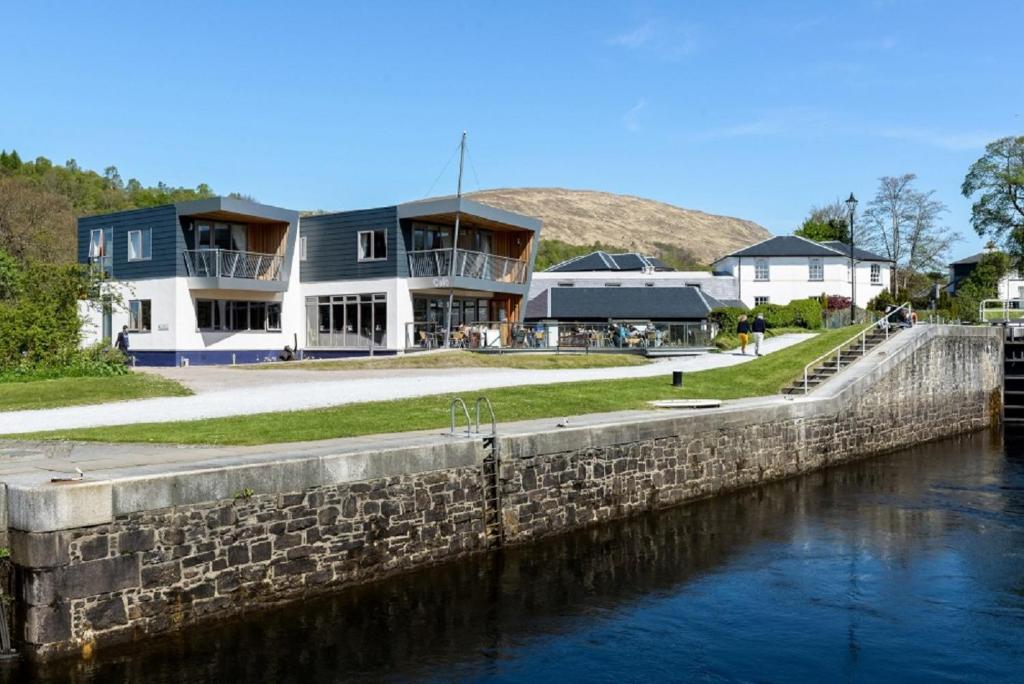 a house on the side of a river at Moorings Hotel in Fort William