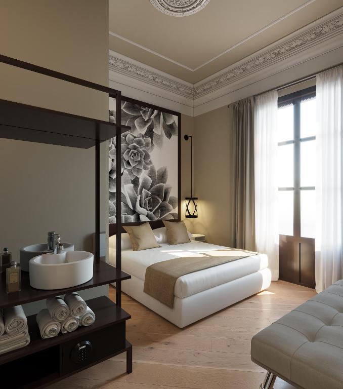 a bedroom with a bed and a sink and a sink at Hostal Central Barcelona in Barcelona