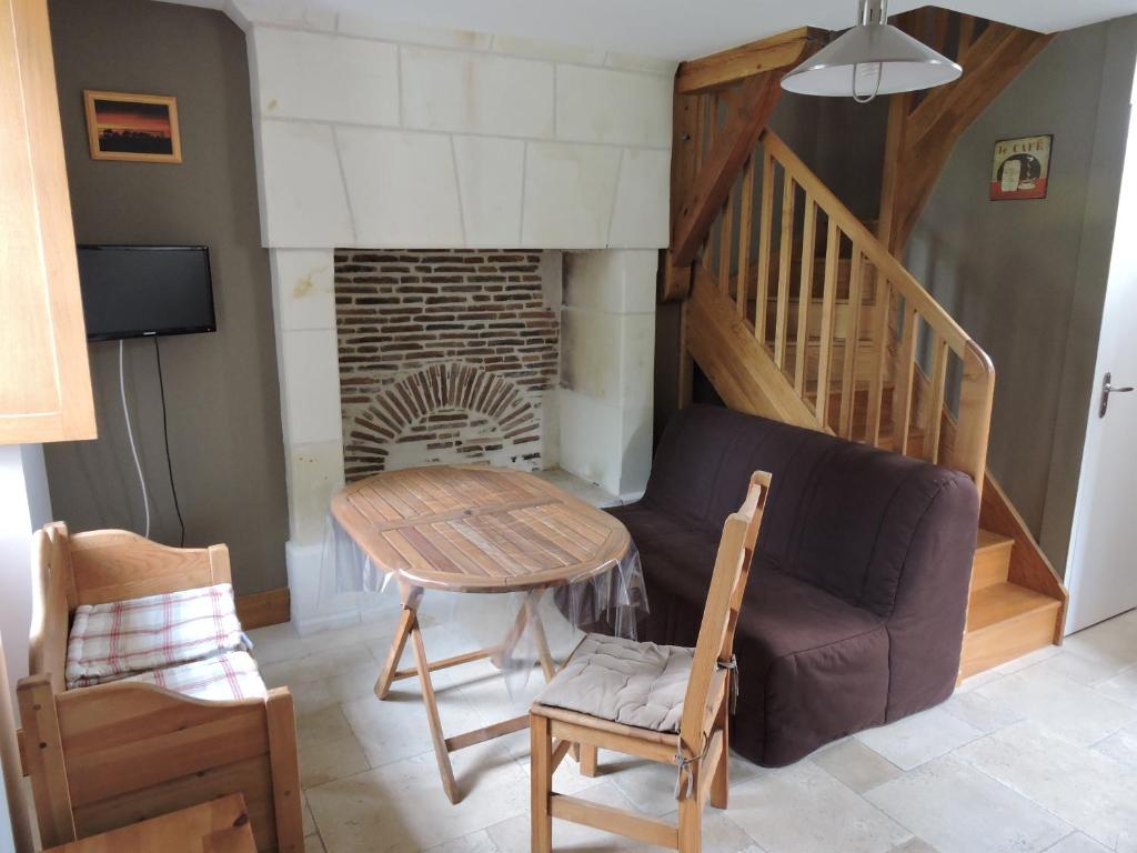 a living room with a couch and a fireplace at Escapade in Mareuil-sur-Cher