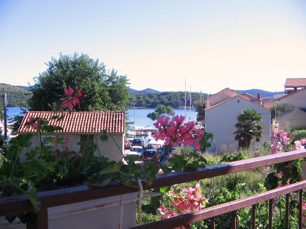 a balcony with a view of a marina at Holiday Home Ena , Mali Iž 286 in Mali Iž