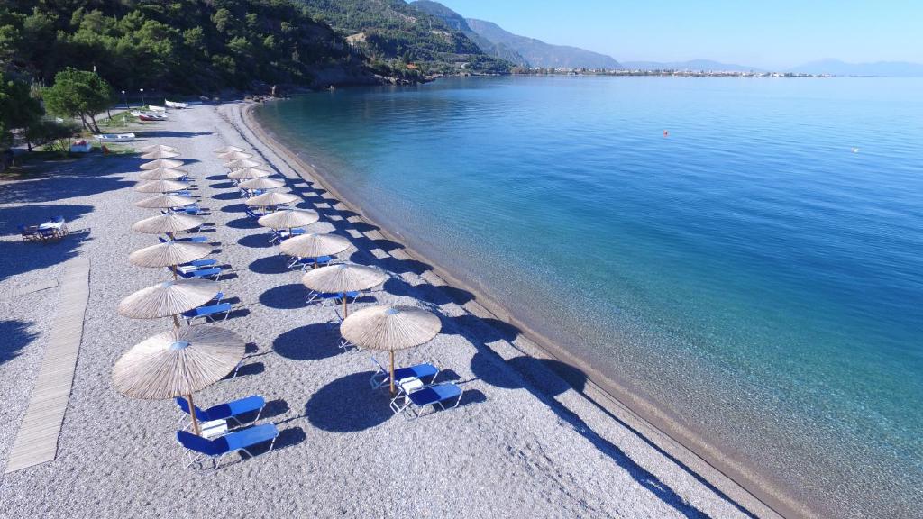 un gruppo di sedie e ombrelloni in spiaggia di Stavento a Diakopto