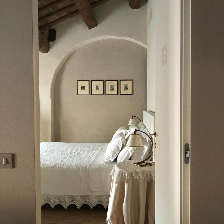 Postel nebo postele na pokoji v ubytování Le Case Di San Vitale