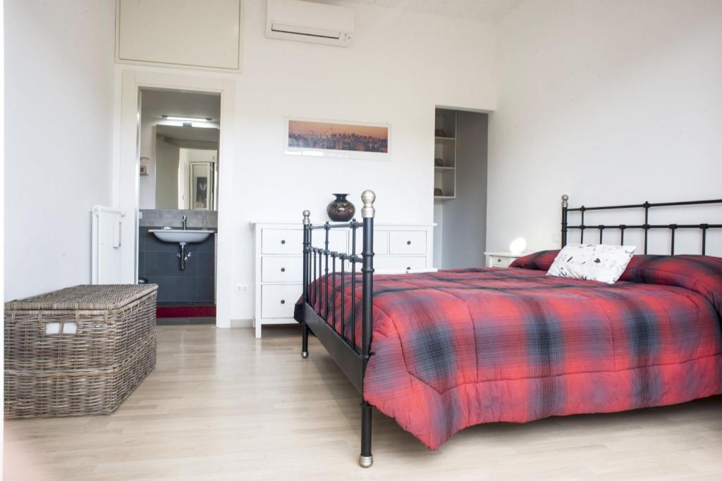a bedroom with a bed and a bathroom with a sink at Suite GG in Vatican in Rome