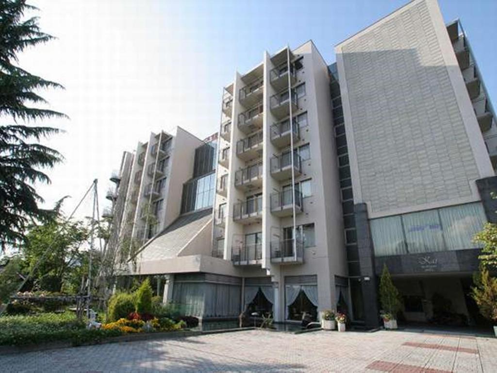 a large apartment building with a lot of windows at Kai Resort Hotel in Fuefuki