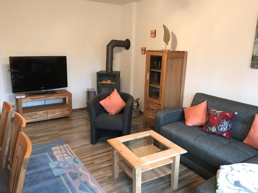 a living room with a couch and a flat screen tv at An der Weissen Mauer 14 Ferienwohnung 1 u 2 in Görlitz