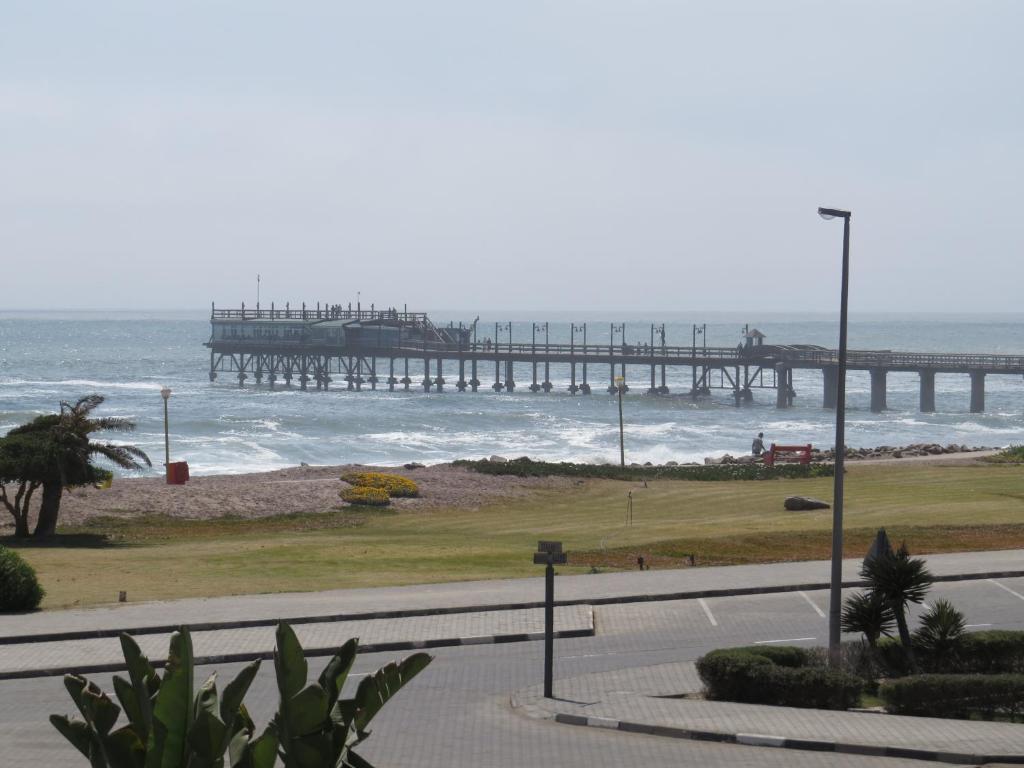 a view of the ocean with a pier in the background at Spoil Yourself in Swakopmund