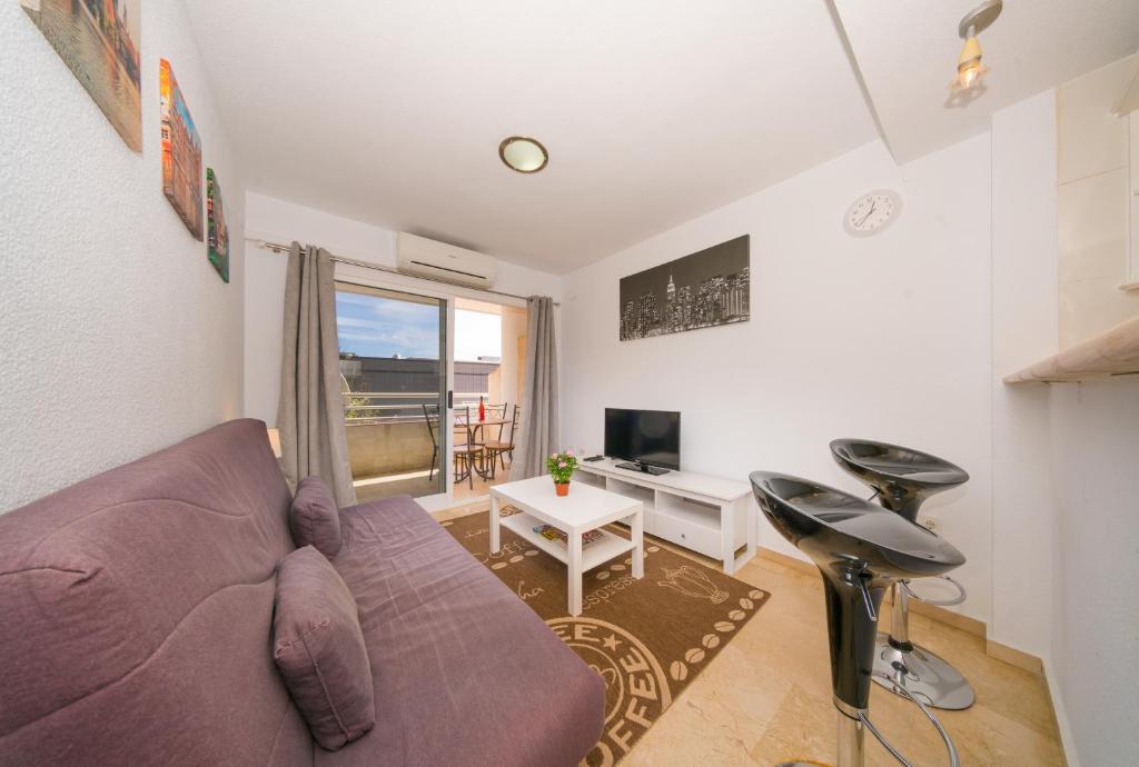 a living room with a purple couch and a desk at Costa Blanca Albir 2 in Albir