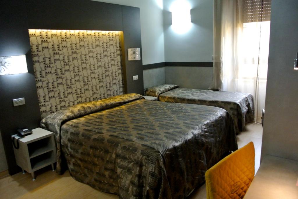 Postel nebo postele na pokoji v ubytování Hotel Dei Mille