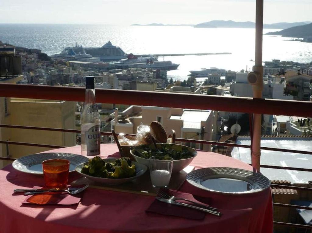 a table with a plate of food on a balcony at Apartment with Amazing View & parking in Kavala