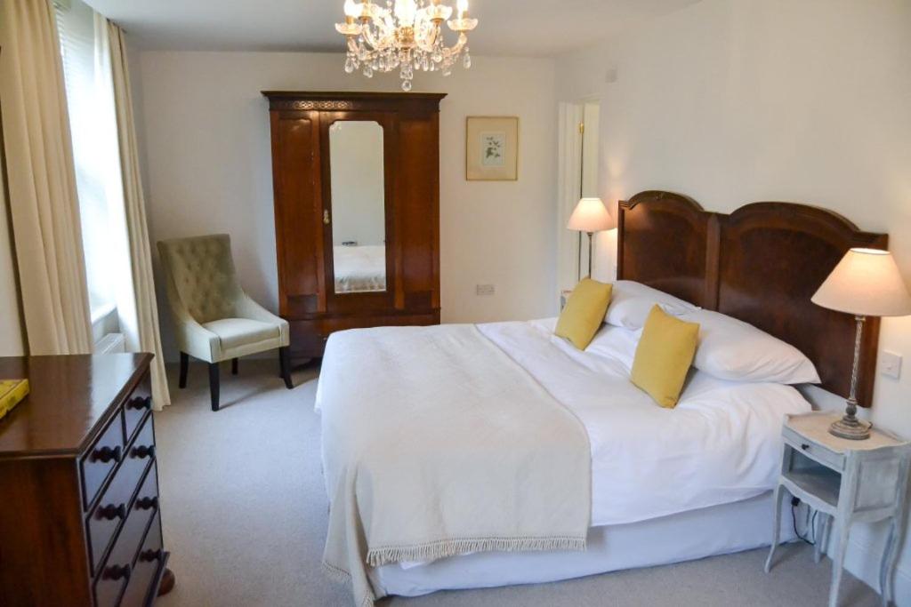 a bedroom with a large bed with yellow pillows at Bang in Wells in Wells next the Sea