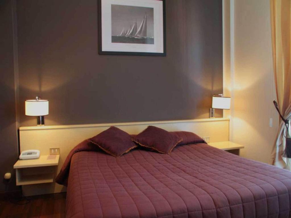 Postel nebo postele na pokoji v ubytování Hotel Ancora Riviera
