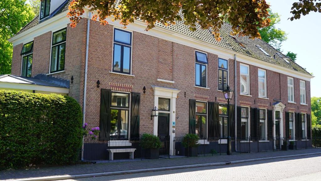 a large brick building on a city street at Room One-Twenty-One in Naarden