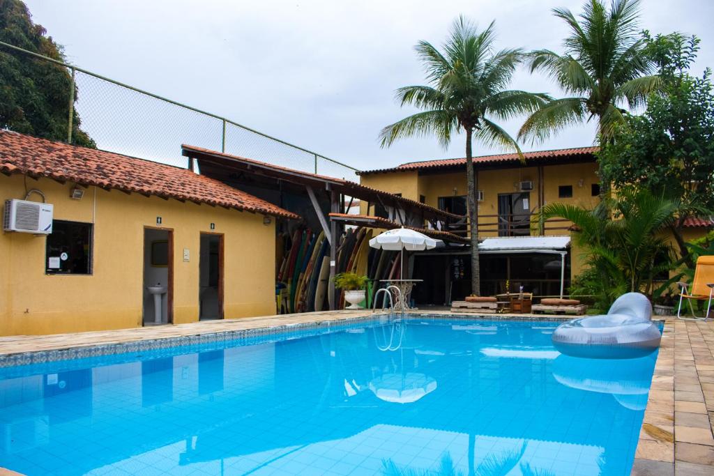 a swimming pool in front of a house at Rio Surf House Hostel e Pousada in Rio de Janeiro