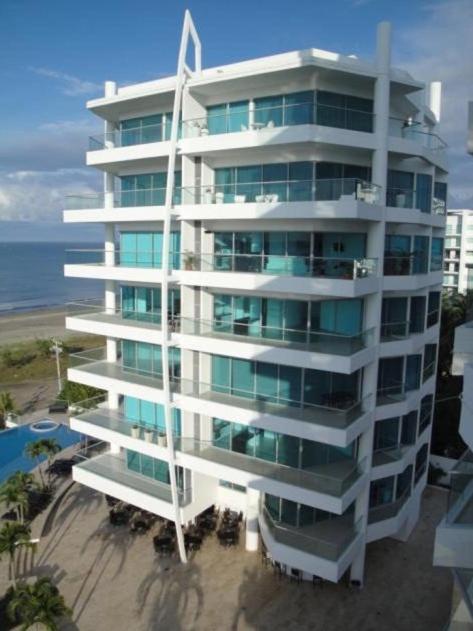 a tall white building next to the ocean at Apartamento Cartagena Alquiler - Edif Seaway 935 in Cartagena de Indias